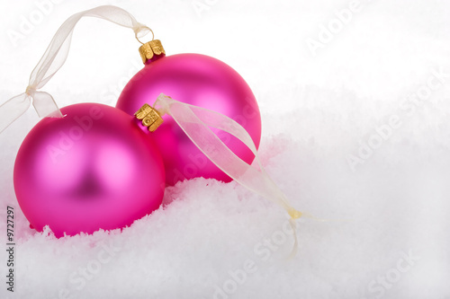 Christmas baubles on snow