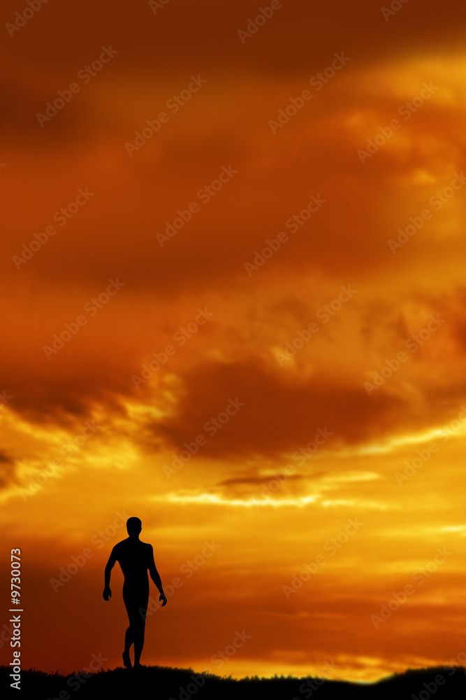 Man silhouetted by sunset  walking in nature