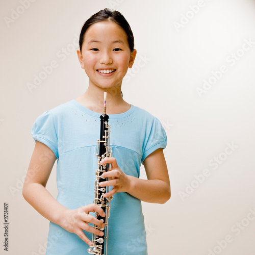 Confident musician holding clarinet Fototapeta