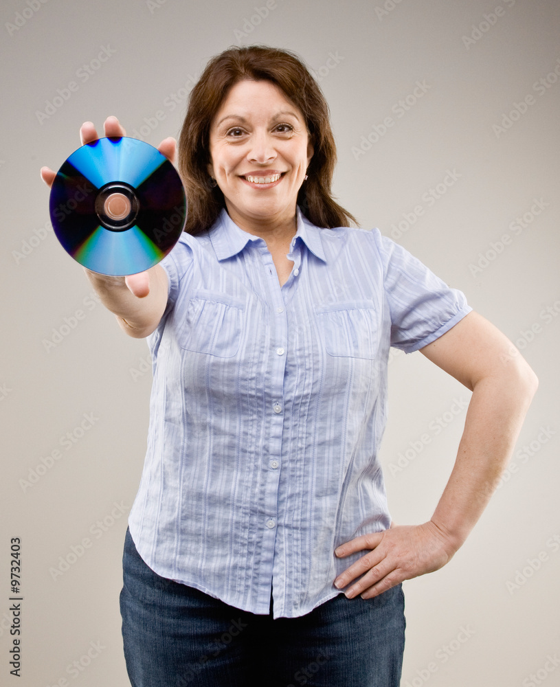 Confident woman proudly holding out compact disc Confident woman proudly holding out compact disc