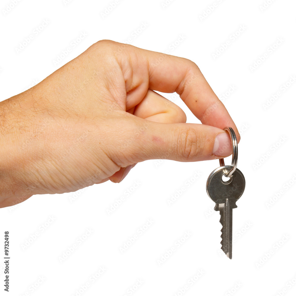 Silver key in a hand isolated on white. Silver key in a hand isolated on white.