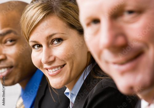 Confident businesswoman with co-workers