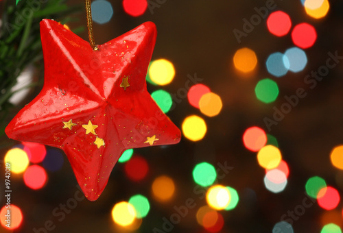 Christmas star on a tree branch, lights background