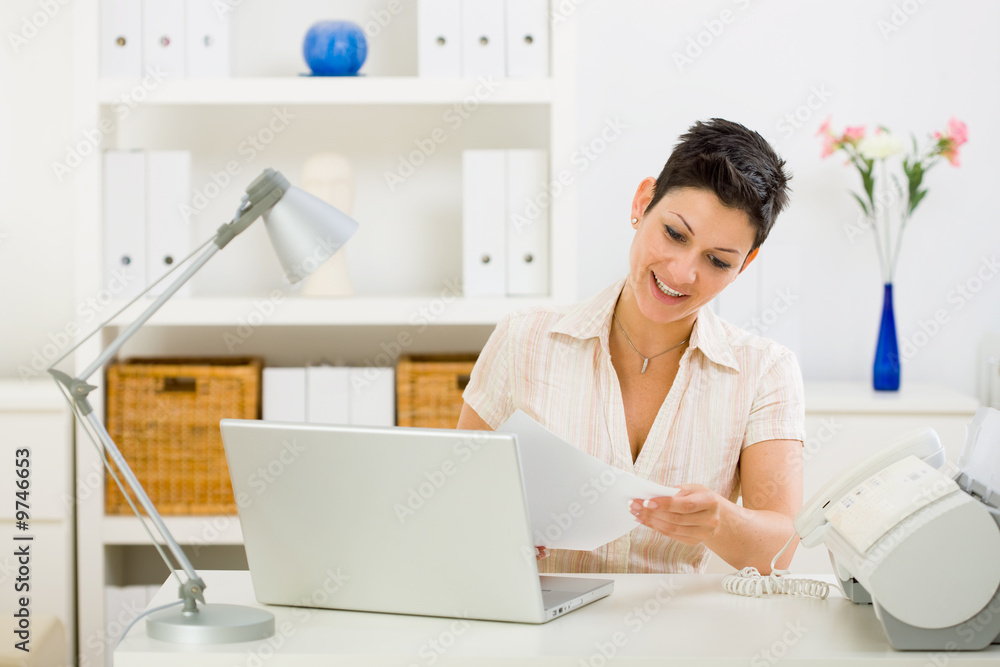Business woman working on laptop computer at home. Business woman working on laptop computer at home.