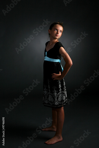 studio portrait of aloof, confident looking young pretty girl