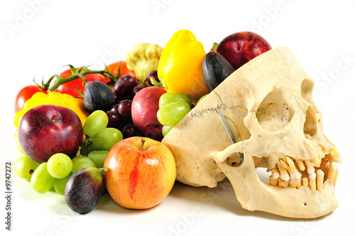 A human skull filled with fruits and vegetables.