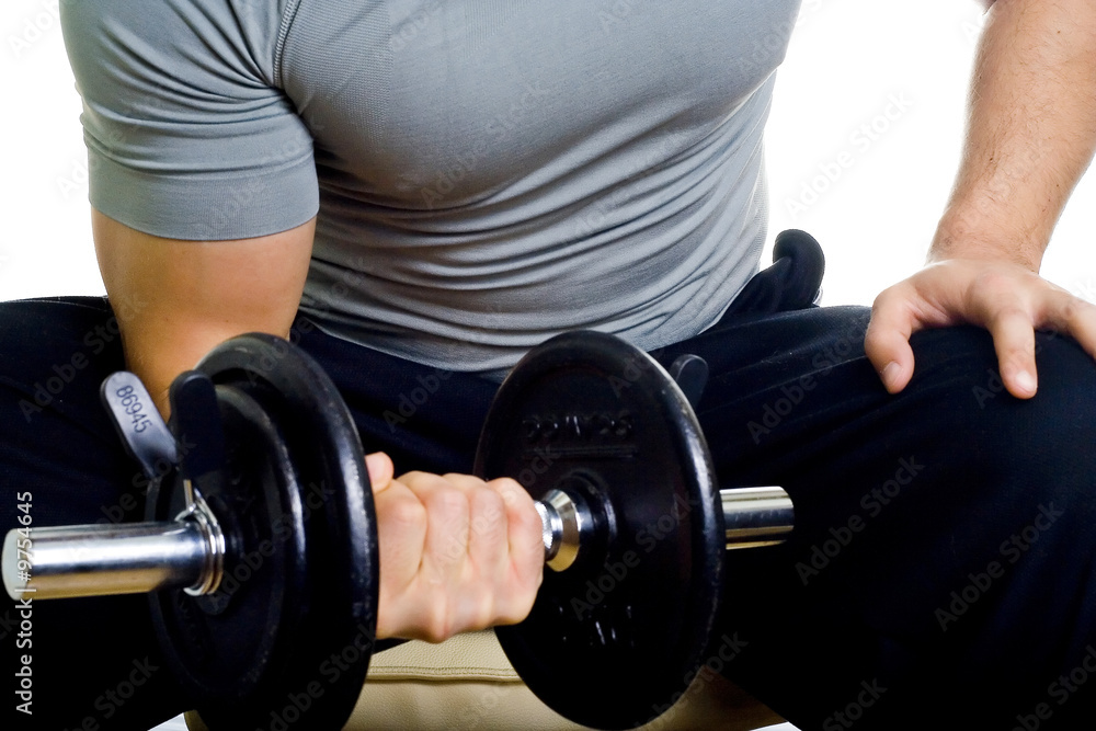 Healthy man hard workout of biceps in gym Healthy man hard workout of biceps in gym