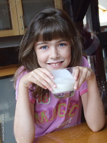 Niña preciosa tomando la leche photo