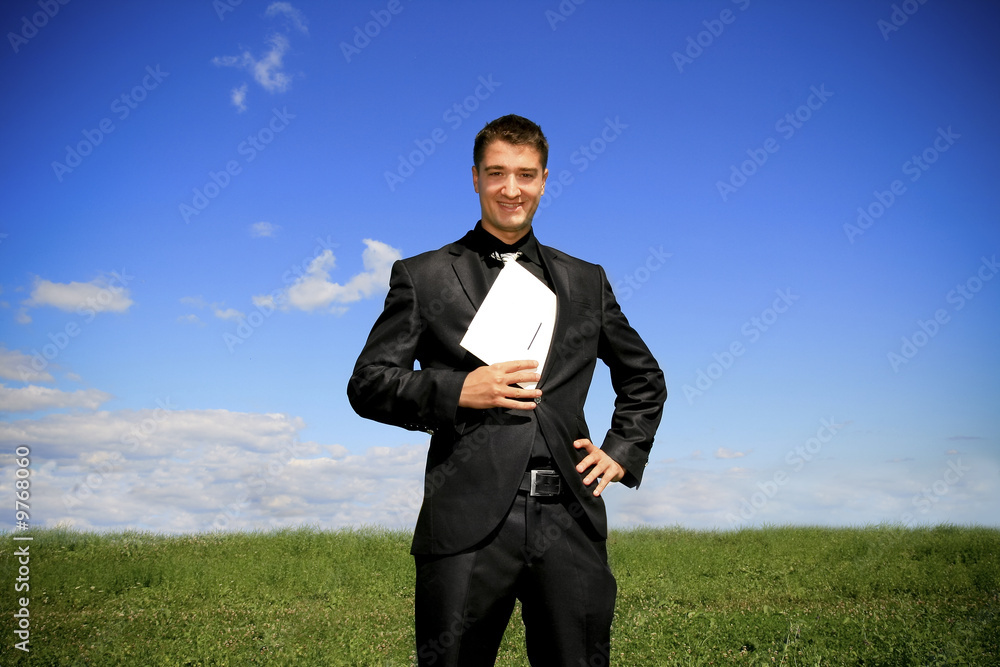 Businessman pulling a folder out his suit. Businessman pulling a folder out his suit.