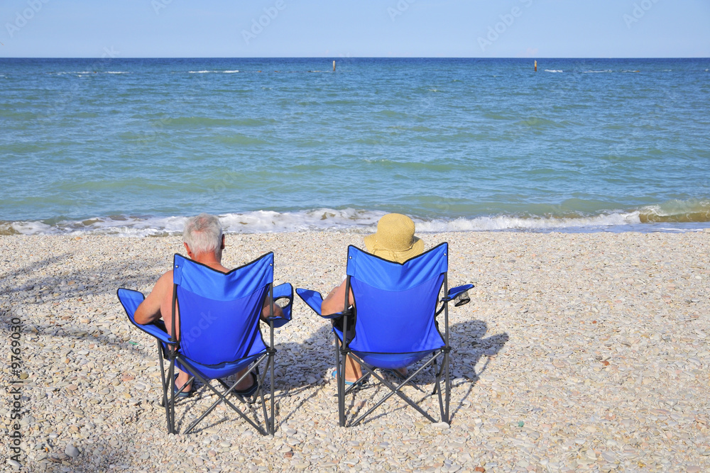 elderly couple on vacation at the beach elderly couple on vacation at the beach