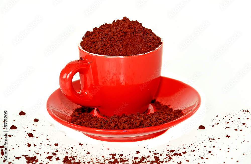 red cup full of coffee granules isolated over white red cup full of coffee granules isolated over white