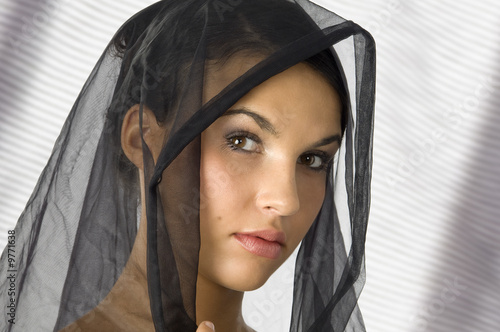 nice portrait of a young woman with a black veil on her head photo