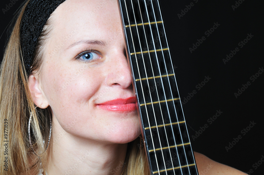 Fototapeta premium portrait of the nice woman behind fretboard