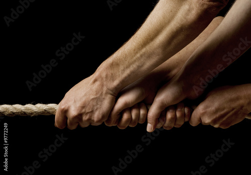 Slika na platnu four hands pulling on a rope in one direction