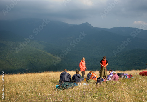 Hikers have a rest on a hillside..