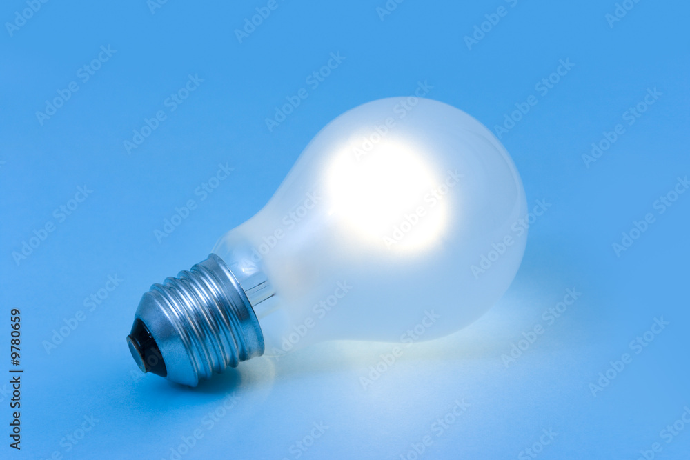 Lighting lamp on blue paper, abstract technology background Lighting lamp on blue paper, abstract technology background