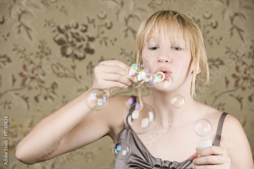 Pretty young girl with blue eyes blowing bubbles © Scott Griessel