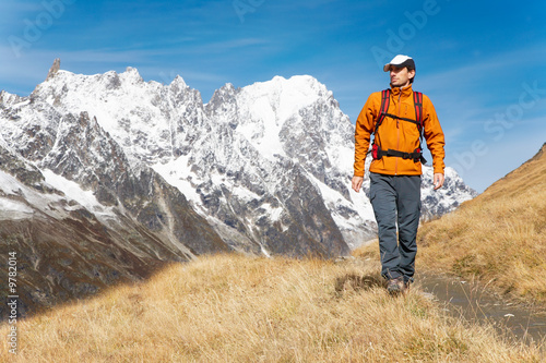 Male trekker walks along a mountain path, Mont Blanc Italy