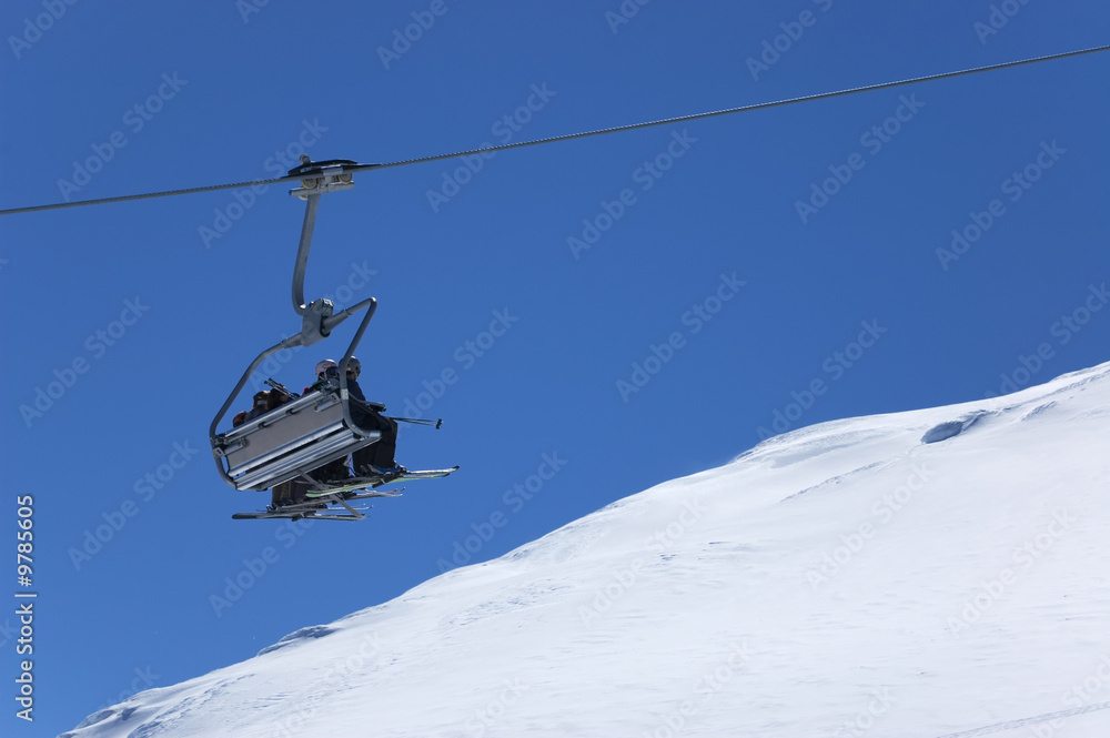 Chair lift with skiers at ski resort. Winter holidays Chair lift with skiers at ski resort. Winter holidays