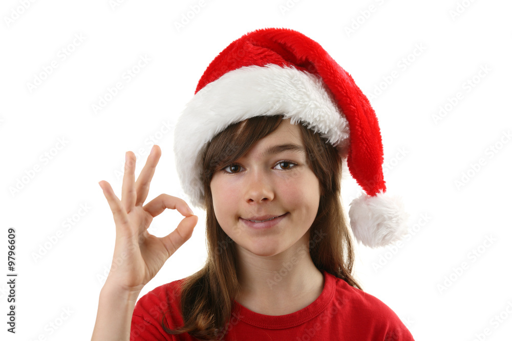 Christmas time - girl with Santa's hat showing OK sign Christmas time - girl with Santa's hat showing OK sign