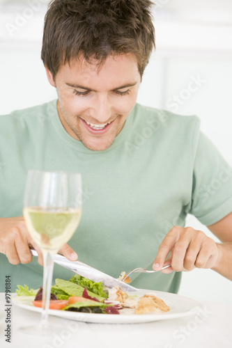 Young Man Enjoying meal mealtime With A Glass Of Wine