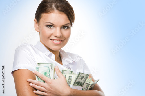 Portrait of young woman holding money