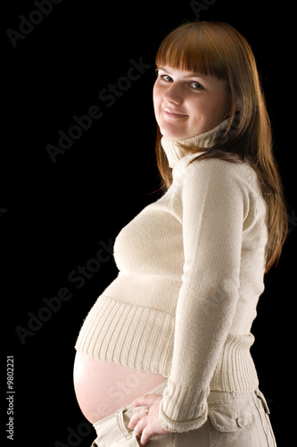 happy pregnant woman portrait isolated on black