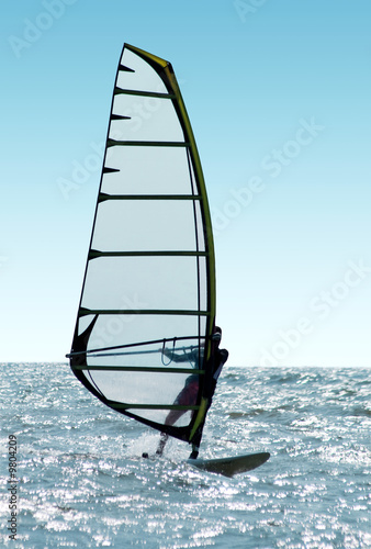 Windsurfer on waves of a sea