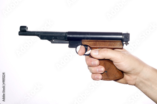 Pneumatic pistol in hand over white