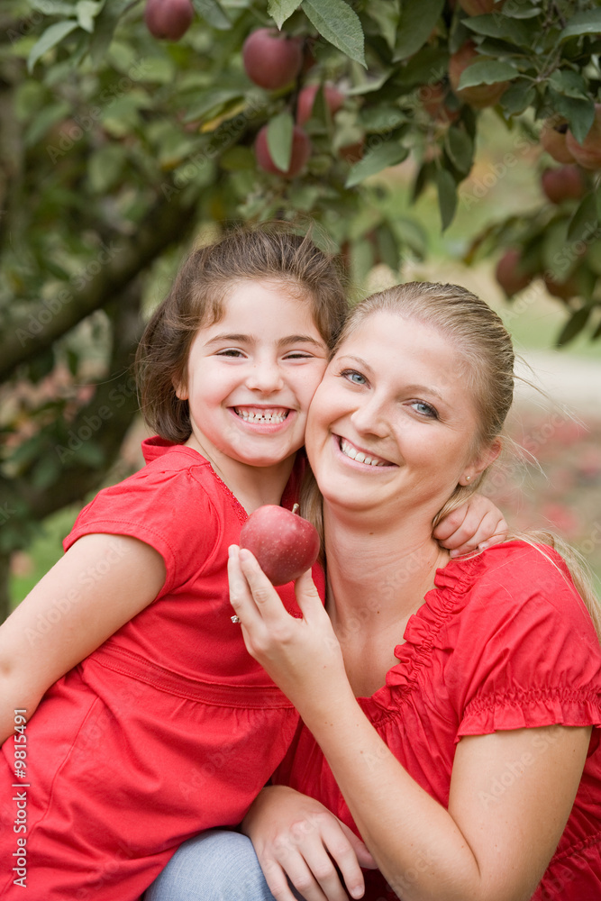 Mother and Daughter in Apple Orchard Mother and Daughter in Apple Orchard