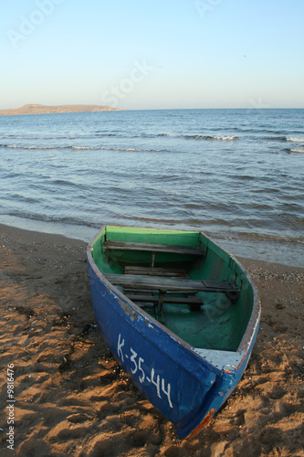 The blue  boat  on the seacoast .