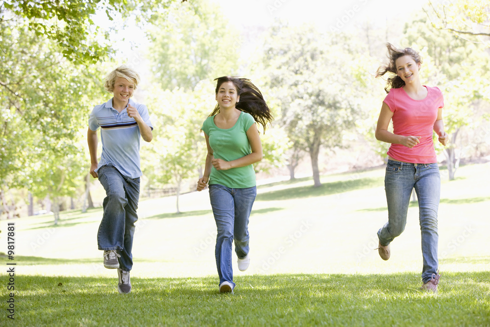 Teenagers Running Through Park