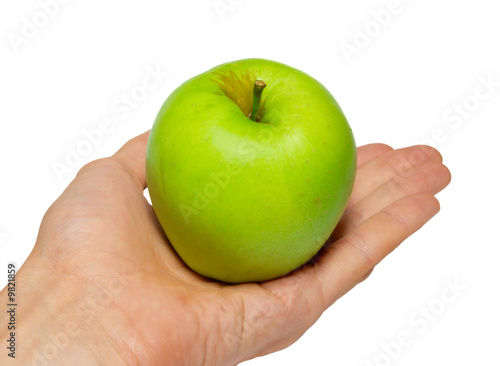 Green tasty apple in a hand isolated on white.