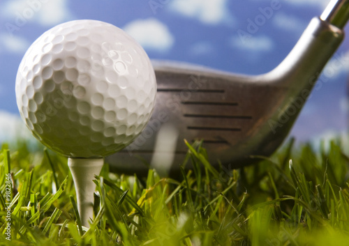 Golf ball on tee with club