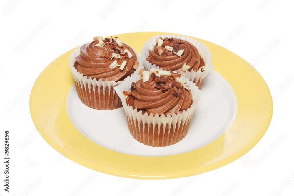 Chocolate cup cakes on a plate isolated on white Chocolate cup cakes on a plate isolated on white