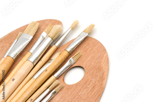 painting brushes and palette on white background.