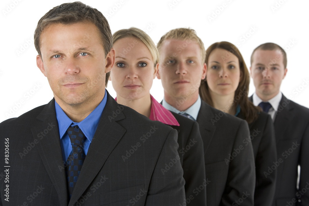 Group Of Business People In A Line Looking Serious Group Of Business People In A Line Looking Serious