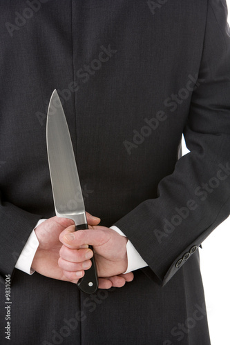 Businessman Holding Knife Behind His Back