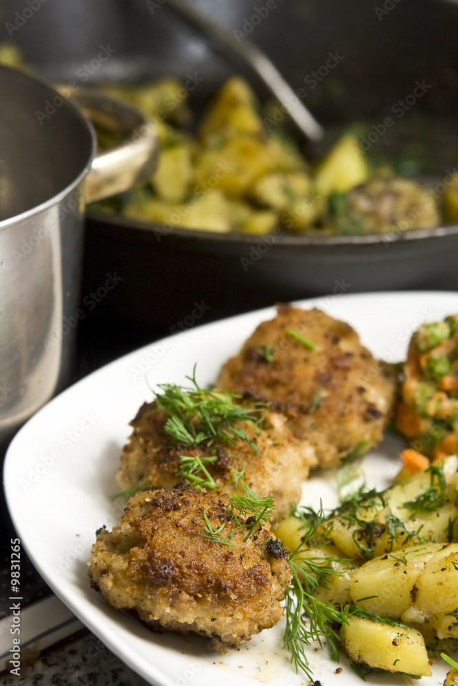 Fototapeta premium Pork burgers with potatoes, carrot and green peas
