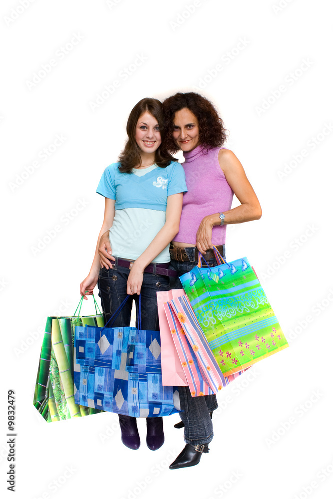 Two young women with bags shopping for Christmas