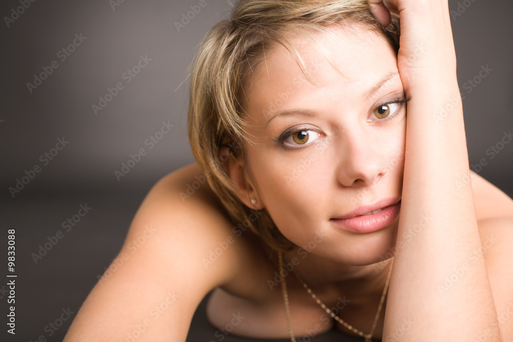 Portrait of attractive nude girl lying on black background Portrait of attractive nude girl lying on black background