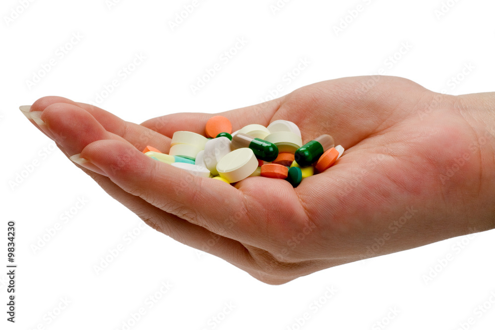 Heap of pills on a palm isolated on white background. Heap of pills on a palm isolated on white background.