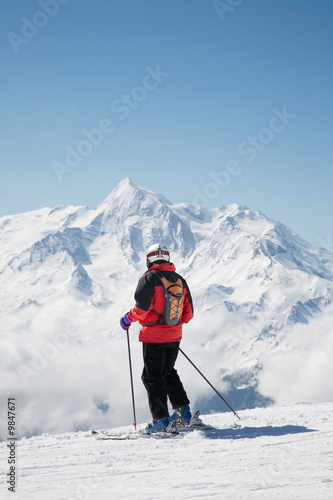 Skier takes a break; in background the french alps, Europe.