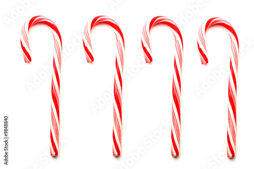 Four red and white Christmas candy canes isolated on white