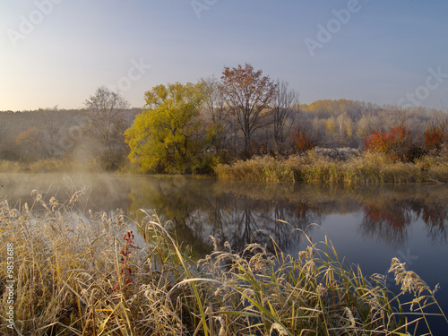 Autumn wood lake and the first morning hoarfrost