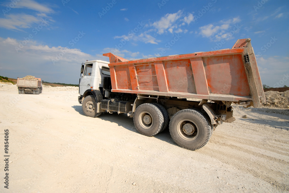 Mining Truck on Blue on  Background of  Blue Sky in Open Pit.