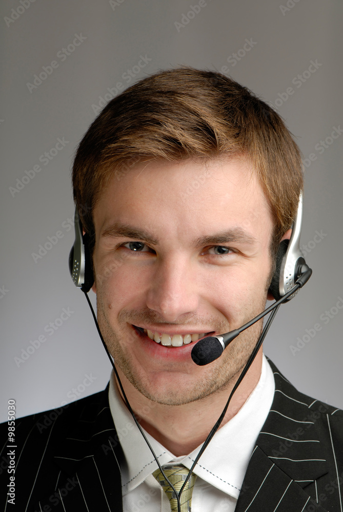young businessman in headphones speaks on microphone young businessman in headphones speaks on microphone