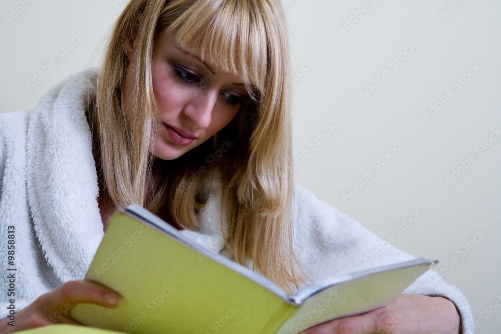Blond model who looks like Paris Hilton is reading a book Blond model who looks like Paris Hilton is reading a book