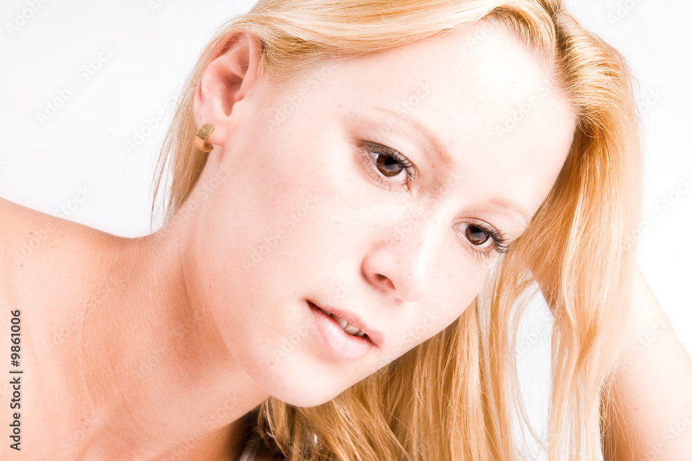Studio portrait of a young blond girl in a thinking pose Studio portrait of a young blond girl in a thinking pose