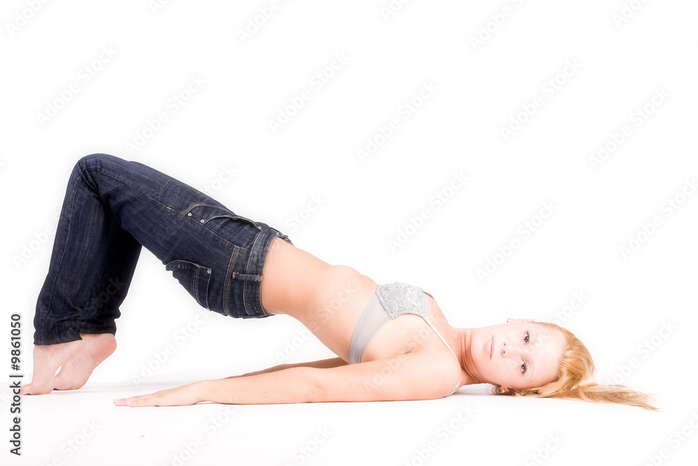 Studio portrait of a young blond girl in bra in a creative pose